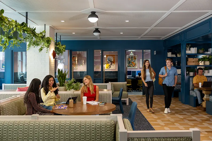 Friends handing out in a large booth