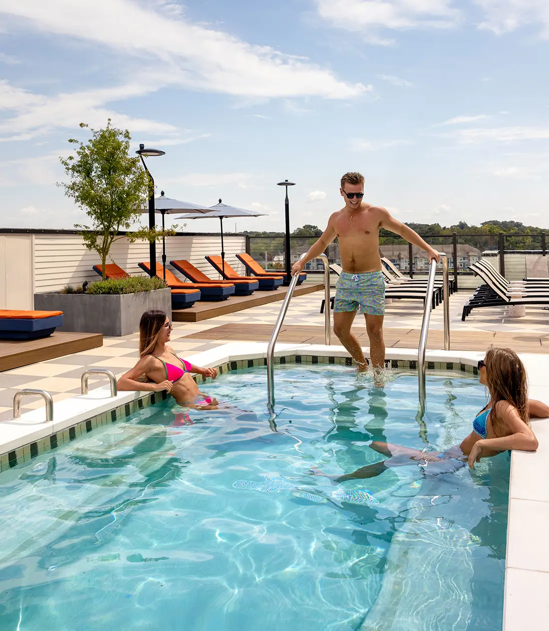 friends hanging out in pool